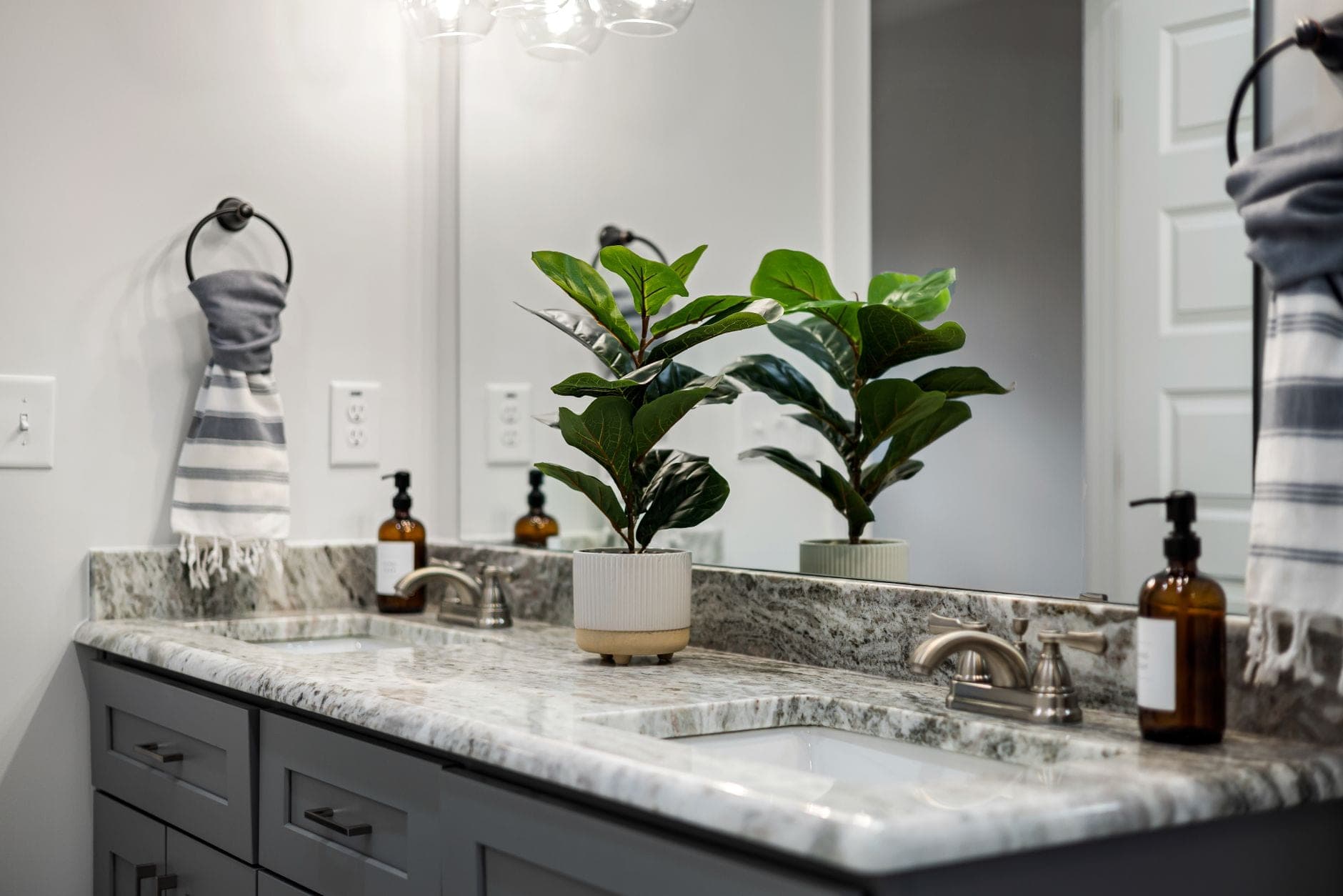 Folded cotton hand towels and washcloths on a marble counter