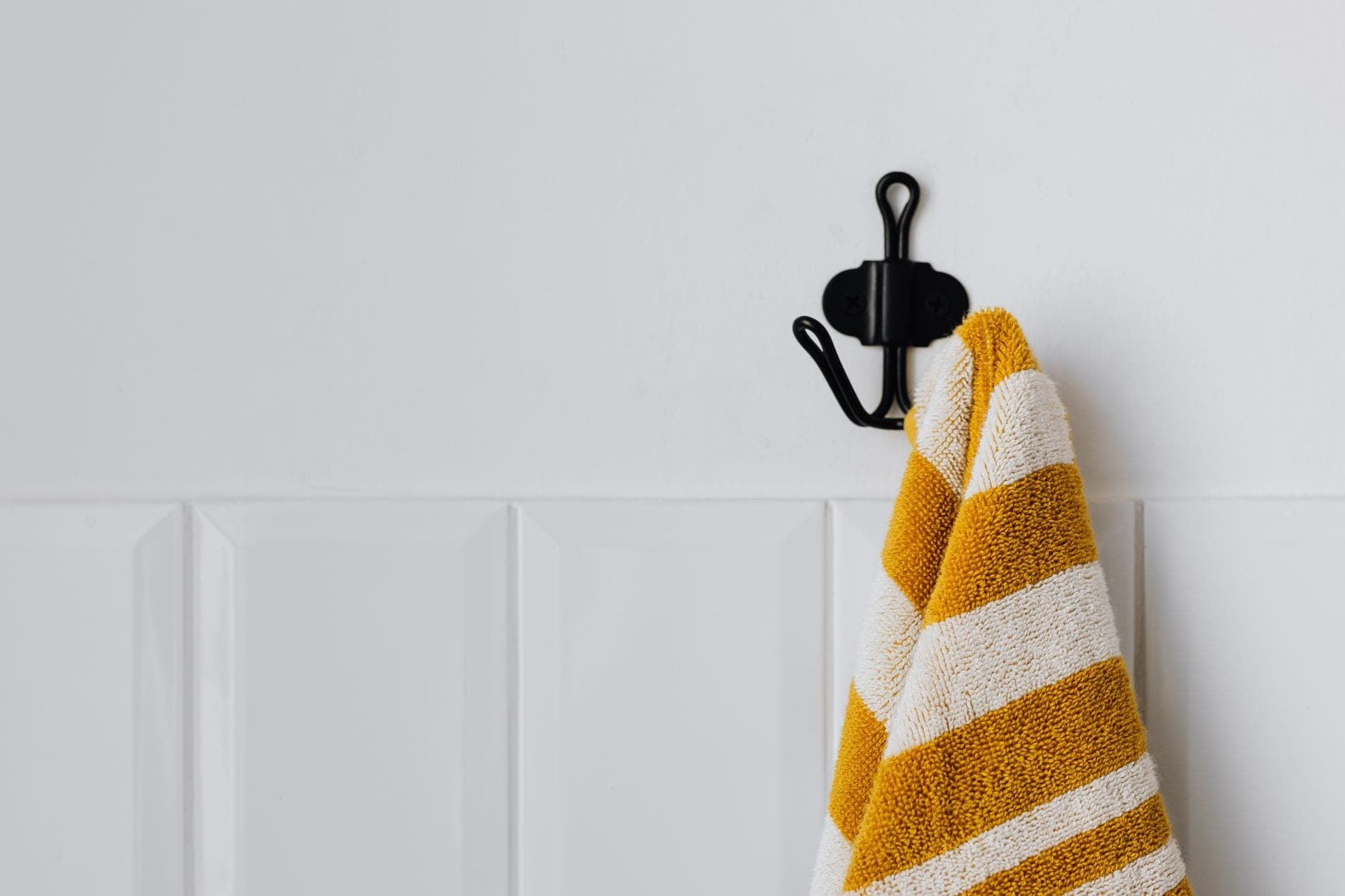 Striped Turkish peshtemal towels with tasselled ends hanging on a rail