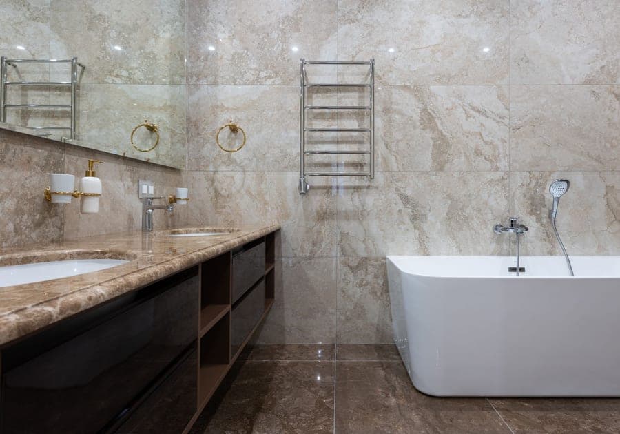Diatomaceous stone bath mat on a tiled bathroom floor