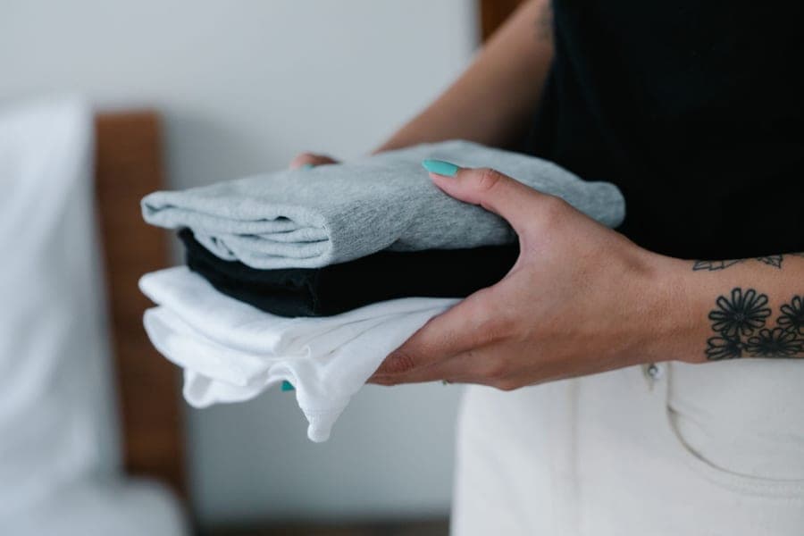 A neat pile of white cotton washcloths